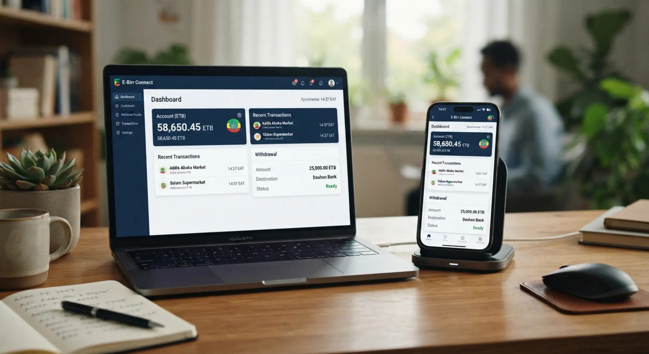 Phone and laptop showing balance and withdrawal dashboard